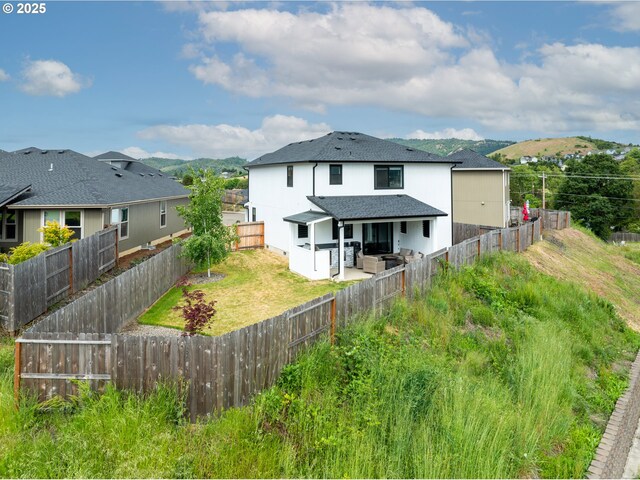 625 Brady Ln, Roseburg, OR 97471 - back of property featuring a patio, a fenced backyard, roof with shingles, and stucco siding
