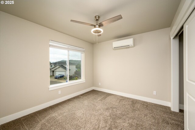 625 Brady Ln, Roseburg, OR 97471 - carpeted spare room featuring an AC wall unit, ceiling fan, and baseboards