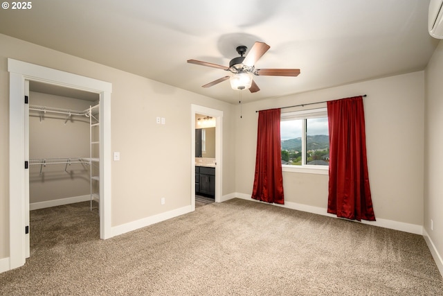 625 Brady Ln, Roseburg, OR 97471 - unfurnished bedroom with carpet flooring, baseboards, a spacious closet, and a wall mounted AC