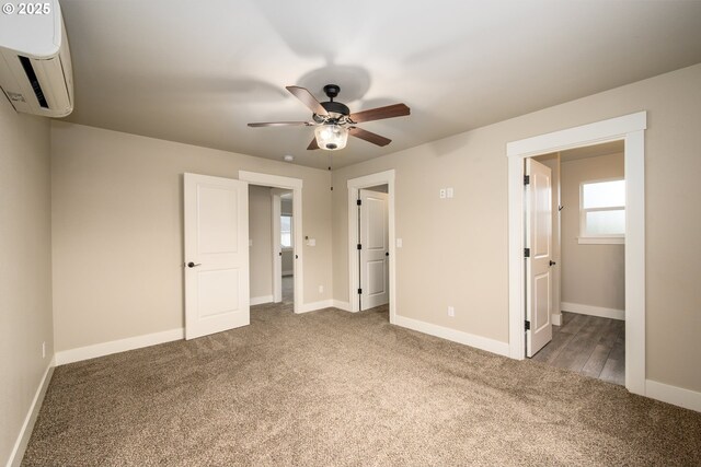 625 Brady Ln, Roseburg, OR 97471 - unfurnished bedroom featuring a wall unit AC, carpet flooring, baseboards, and ceiling fan