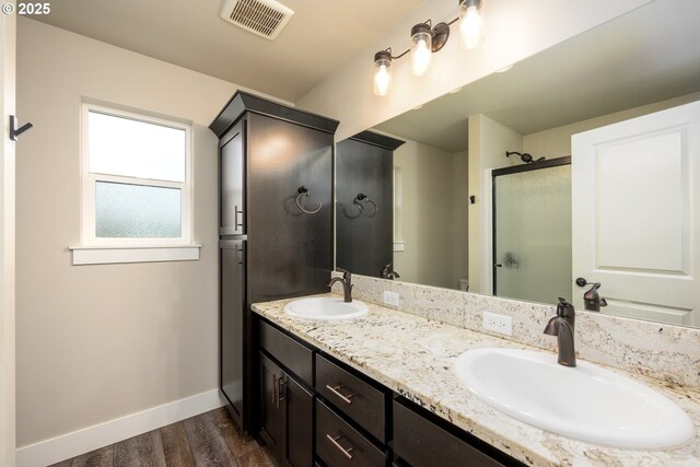 625 Brady Ln, Roseburg, OR 97471 - bathroom featuring wood finished floors, baseboards, a shower stall, and double vanity