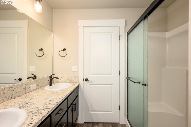 625 Brady Ln, Roseburg, OR 97471 - full bath with double vanity, a stall shower, and wood finished floors