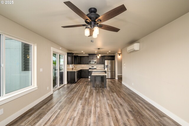 625 Brady Ln, Roseburg, OR 97471 - kitchen with appliances with stainless steel finishes, a wall unit AC, light countertops, and wood finished floors