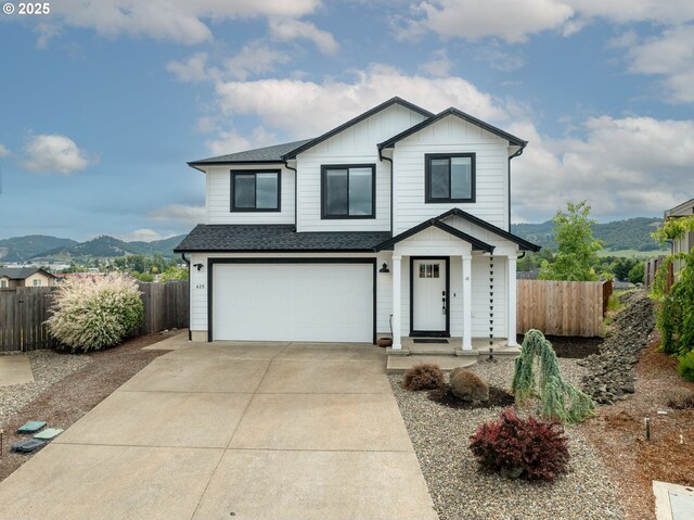 625 Brady Ln, Roseburg, OR 97471 - view of front of property featuring a mountain view, roof with shingles, an attached garage, driveway, and board and batten siding