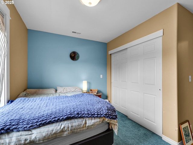 bedroom featuring a closet, carpet flooring, and visible vents