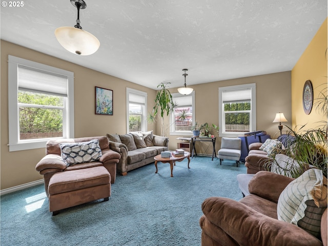 living room with carpet flooring, baseboards, and a healthy amount of sunlight