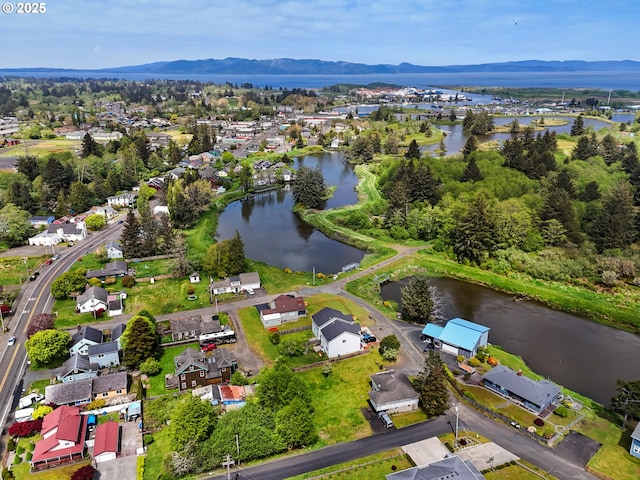 birds eye view of property with a residential view and a water and mountain view
