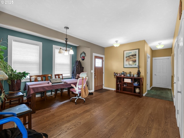 dining room with baseboards and wood finished floors