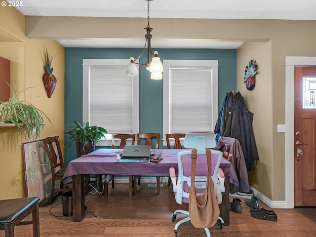 dining room featuring baseboards and wood finished floors