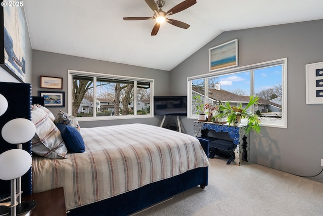 bedroom with ceiling fan, carpet flooring, and vaulted ceiling