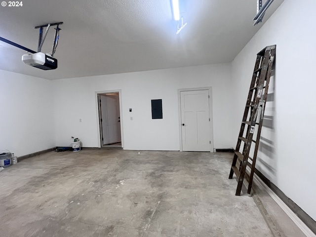 garage with electric panel and a garage door opener