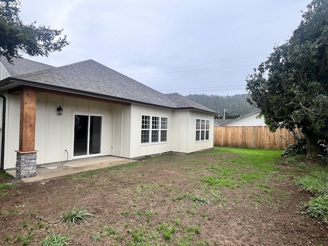 rear view of property with a lawn and a patio area