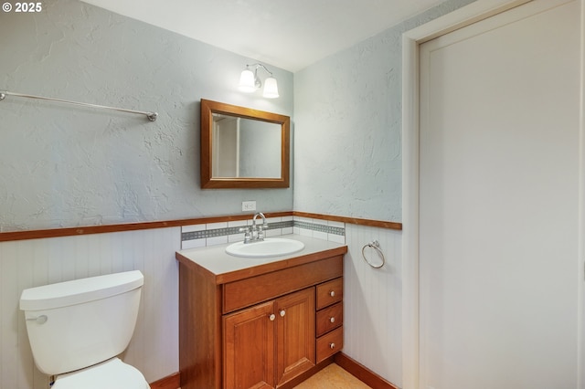 2362 Charnelton St, Eugene, OR 97405 - bathroom featuring a wainscoted wall, vanity, and a textured wall