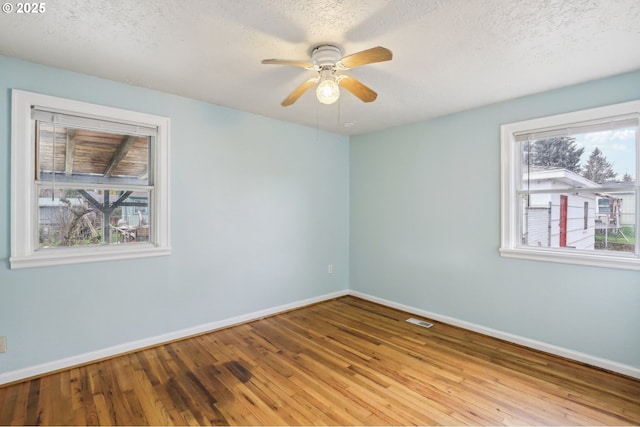 7515 SE Luther Rd, Portland, OR 97206 - spare room with baseboards, hardwood / wood-style floors, a ceiling fan, and a textured ceiling