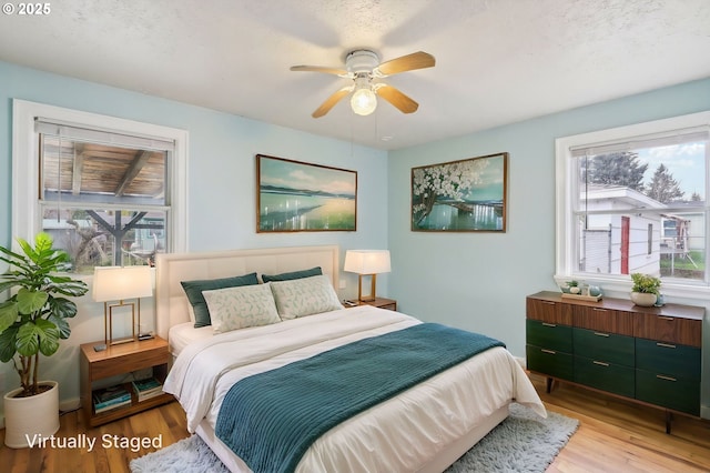7515 SE Luther Rd, Portland, OR 97206 - bedroom featuring multiple windows, light wood finished floors, and a ceiling fan
