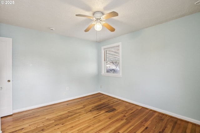 7515 SE Luther Rd, Portland, OR 97206 - spare room featuring wood finished floors, baseboards, a ceiling fan, a smoke detector, and a textured ceiling