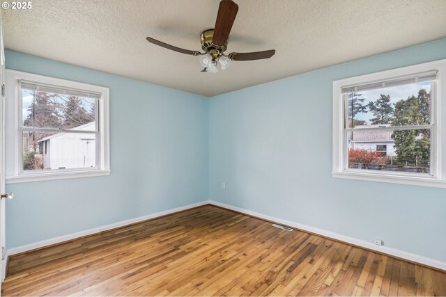 7515 SE Luther Rd, Portland, OR 97206 - spare room featuring baseboards, hardwood / wood-style flooring, a textured ceiling, and a ceiling fan