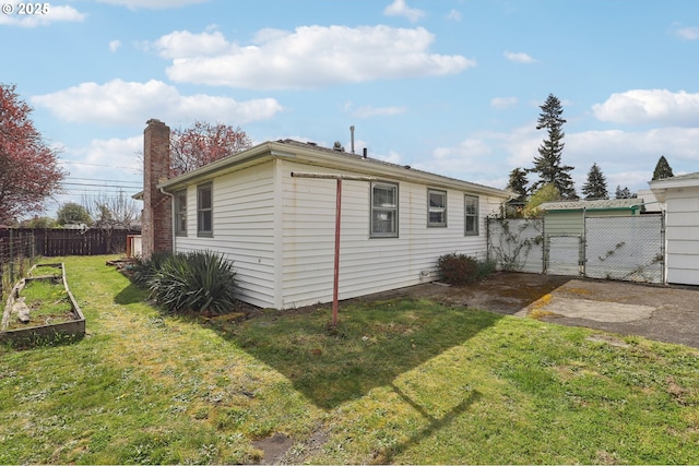 7515 SE Luther Rd, Portland, OR 97206 - rear view of house with a vegetable garden and a chimney