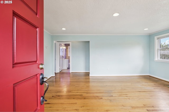7515 SE Luther Rd, Portland, OR 97206 - unfurnished room featuring a textured ceiling, baseboards, light wood-style flooring, crown molding, and recessed lighting