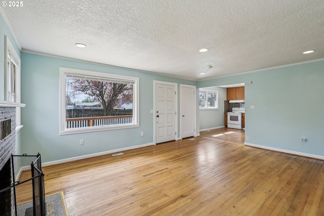 7515 SE Luther Rd, Portland, OR 97206 - unfurnished living room with a fireplace, light wood-style floors, crown molding, a textured ceiling, and baseboards