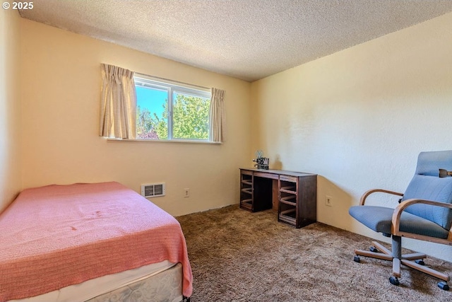 bedroom featuring carpet floors, a textured ceiling, and visible vents