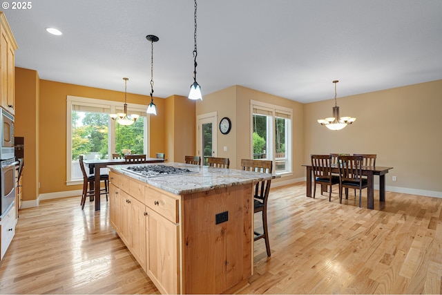 14386 NW Tripton Ct, Beaverton, OR 97006 - kitchen featuring a chandelier, appliances with stainless steel finishes, a kitchen breakfast bar, plenty of natural light, and recessed lighting