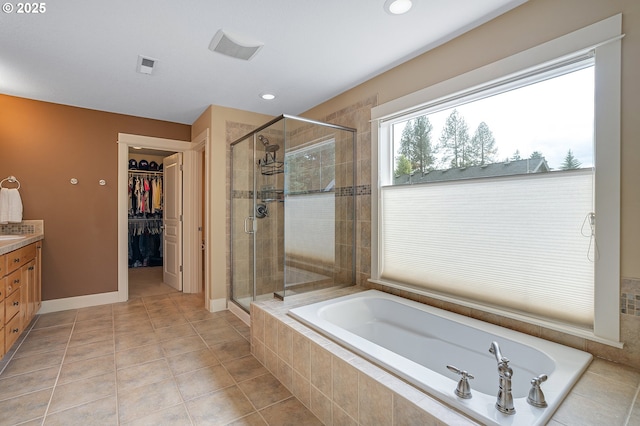 14386 NW Tripton Ct, Beaverton, OR 97006 - full bathroom with a bath, a shower stall, vanity, a spacious closet, and recessed lighting