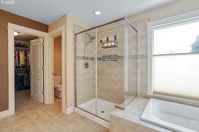 14386 NW Tripton Ct, Beaverton, OR 97006 - bathroom featuring a stall shower, a garden tub, tile patterned flooring, a spacious closet, and recessed lighting