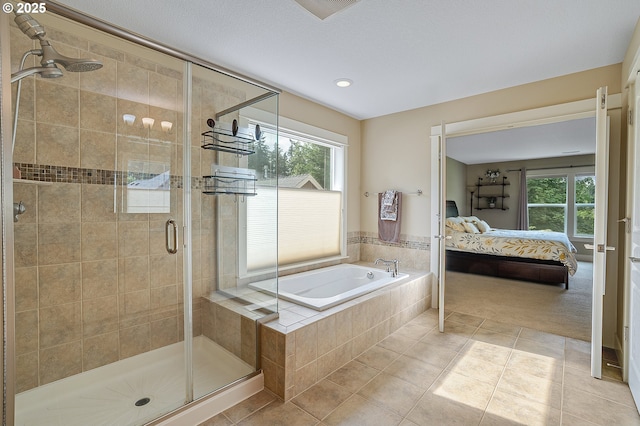 14386 NW Tripton Ct, Beaverton, OR 97006 - bathroom featuring ensuite bath, a garden tub, healthy amount of natural light, a shower stall, and recessed lighting