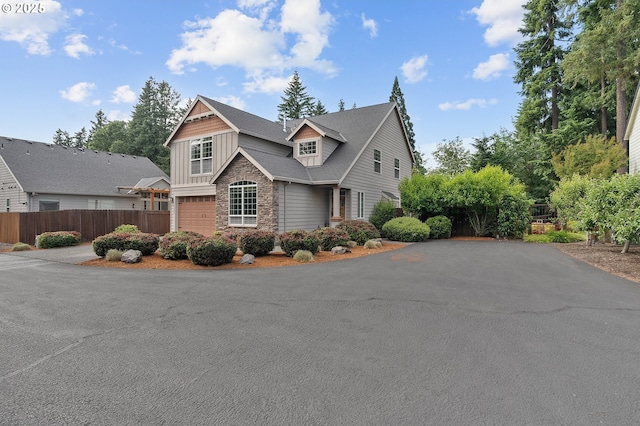 14386 NW Tripton Ct, Beaverton, OR 97006 - view of front facade with stone siding, driveway, and board and batten siding