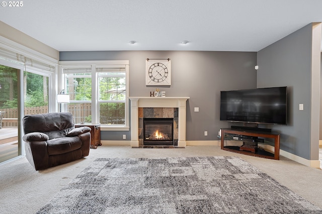 14386 NW Tripton Ct, Beaverton, OR 97006 - carpeted living room featuring a tiled fireplace and baseboards