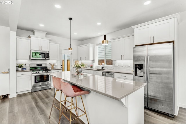 837 S 26th Ave, Cornelius, OR 97113 - kitchen featuring appliances with stainless steel finishes, a center island, tasteful backsplash, white cabinetry, and recessed lighting