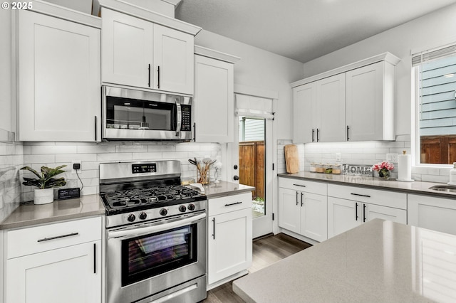 837 S 26th Ave, Cornelius, OR 97113 - kitchen with appliances with stainless steel finishes, white cabinetry, and dark wood-style floors