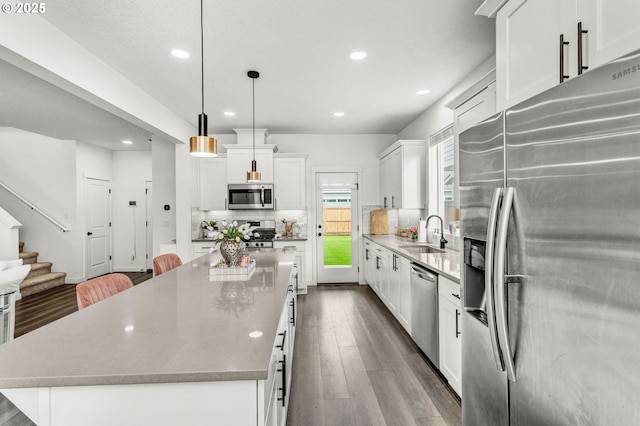 837 S 26th Ave, Cornelius, OR 97113 - kitchen with stainless steel appliances, a kitchen island, recessed lighting, decorative backsplash, and white cabinets