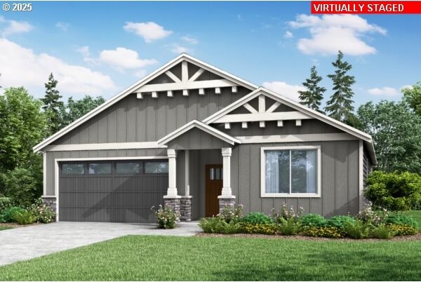 craftsman inspired home with driveway, board and batten siding, an attached garage, and a front yard