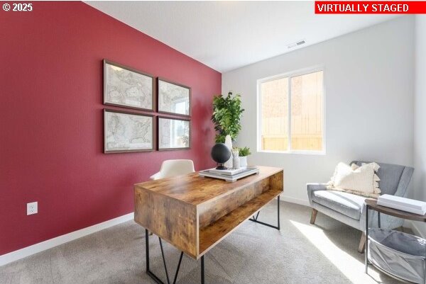 carpeted office space featuring visible vents and baseboards