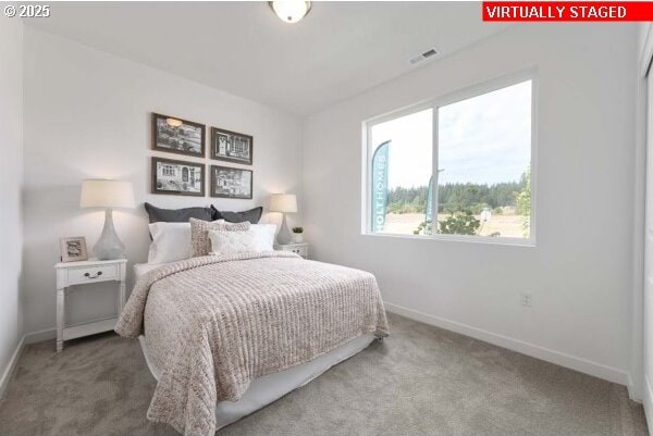 carpeted bedroom with baseboards and visible vents