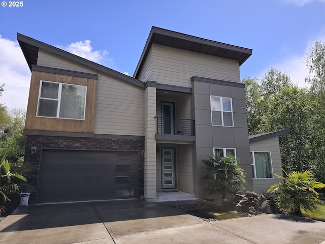 202 NW Quail Gardens Pl, Hillsboro, OR 97124 - modern home featuring a balcony, driveway, a garage, and stone siding