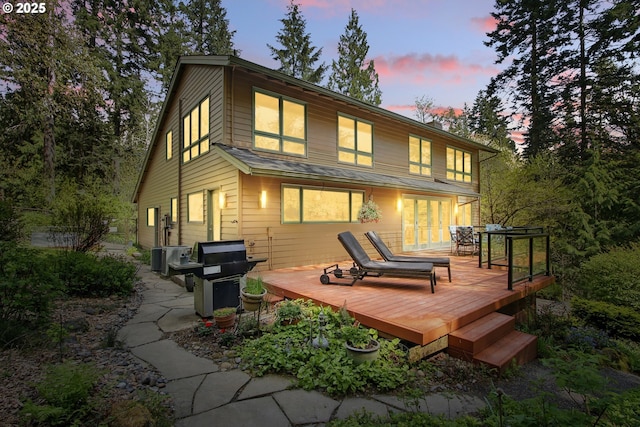 rear view of property with a wooden deck