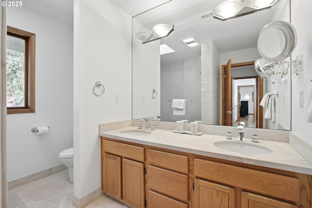 full bath featuring a sink, tile patterned flooring, toilet, and double vanity