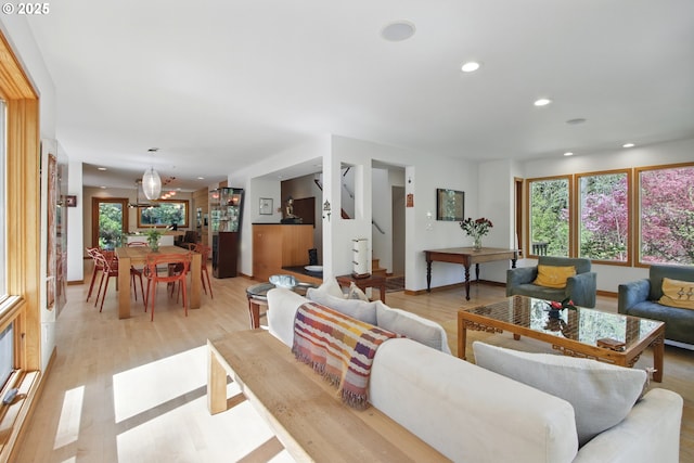living area with light wood-style floors, recessed lighting, and a wealth of natural light