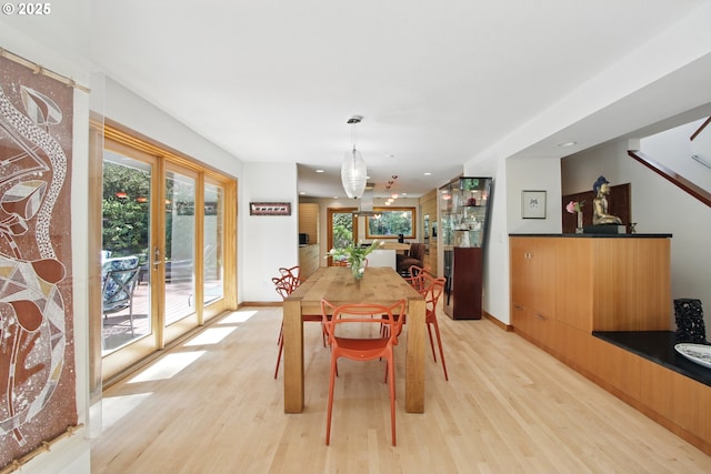 dining room with baseboards, recessed lighting, and light wood-style flooring