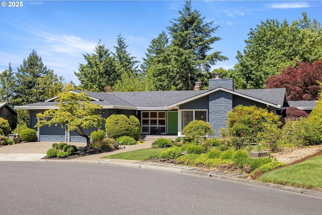 2395 SW Timberline Dr, Portland, OR 97225 - mid-century modern home featuring concrete driveway, an attached garage, and a chimney