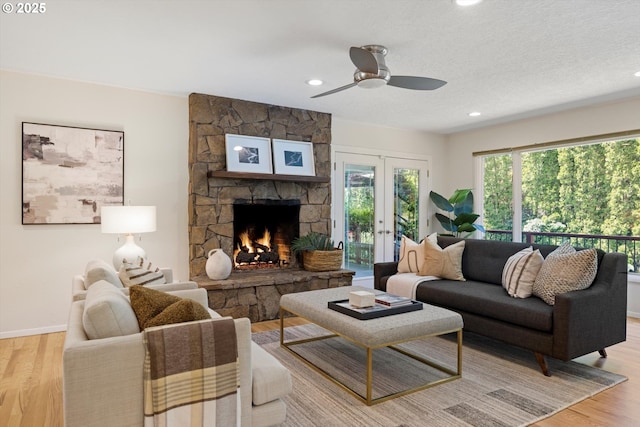 2395 SW Timberline Dr, Portland, OR 97225 - living area with light wood finished floors, a ceiling fan, a fireplace, recessed lighting, and baseboards