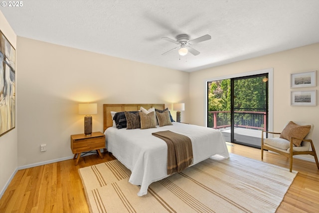 2395 SW Timberline Dr, Portland, OR 97225 - bedroom featuring access to exterior, light wood-style floors, baseboards, ceiling fan, and a textured ceiling