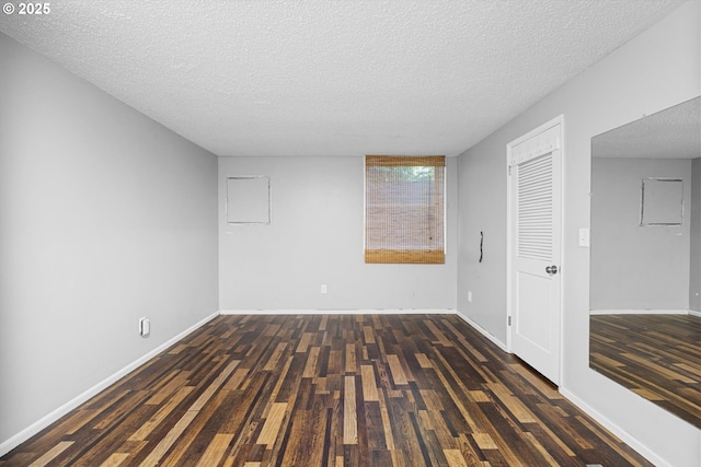 2395 SW Timberline Dr, Portland, OR 97225 - spare room featuring a textured ceiling, wood finished floors, and baseboards