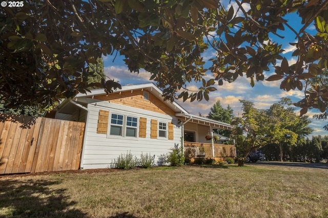 exterior space with a porch, a front yard, and fence