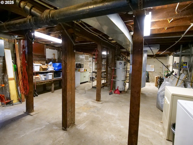 unfinished below grade area with strapped water heater and washer and clothes dryer