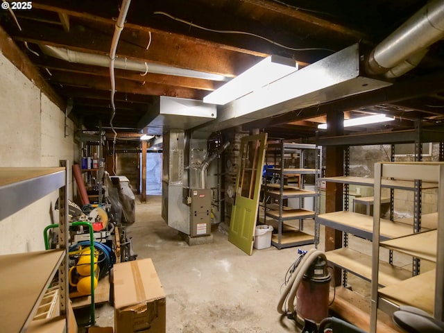 unfinished basement featuring heating unit