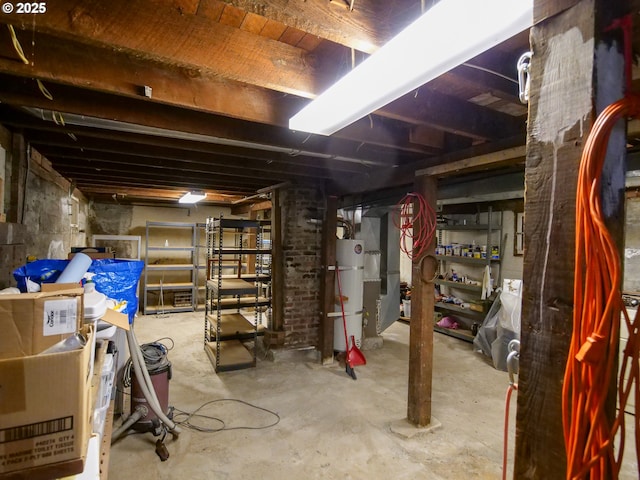 unfinished below grade area featuring strapped water heater